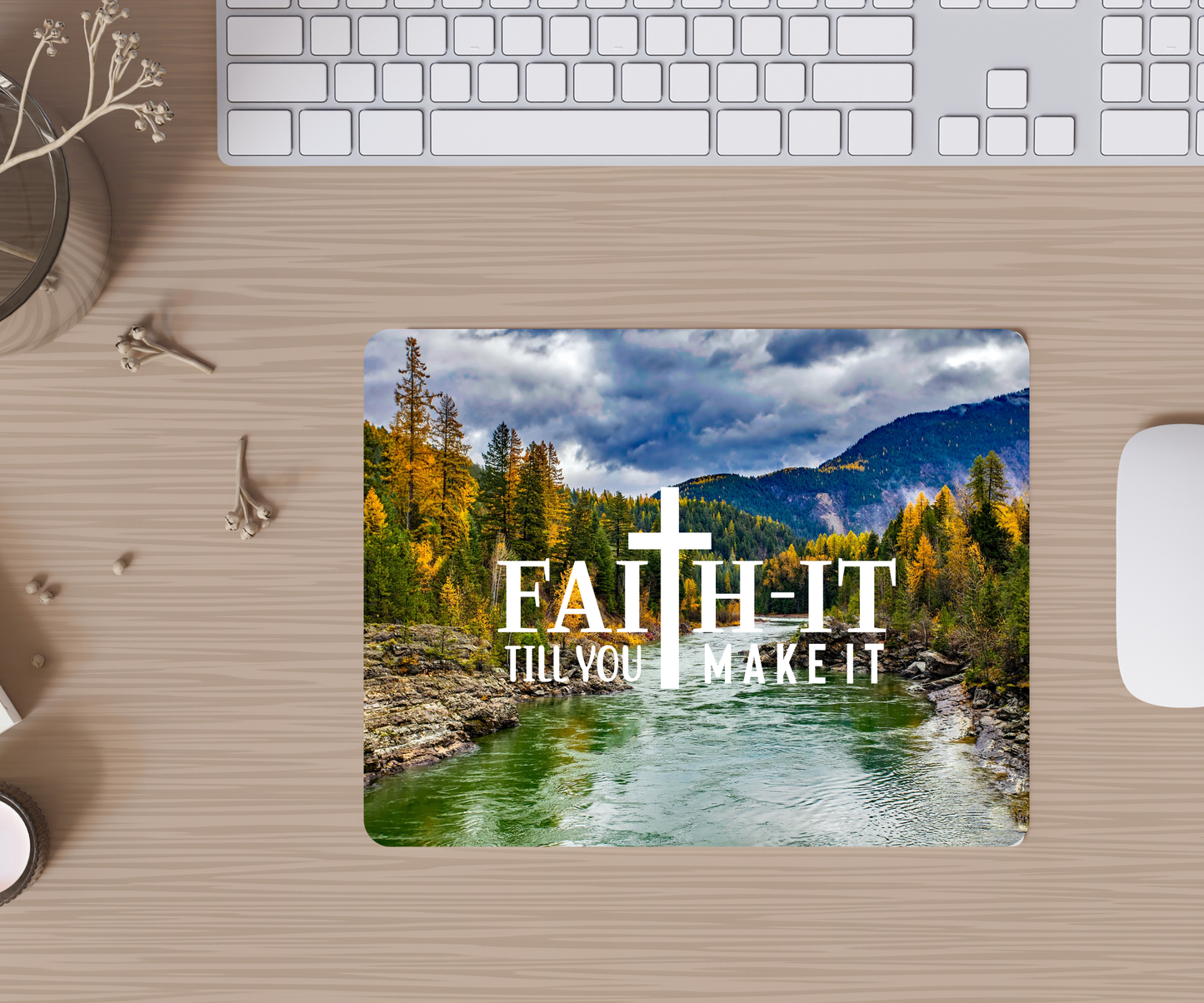 Desk setup with a mouse pad featuring a scenic design and motivational text.