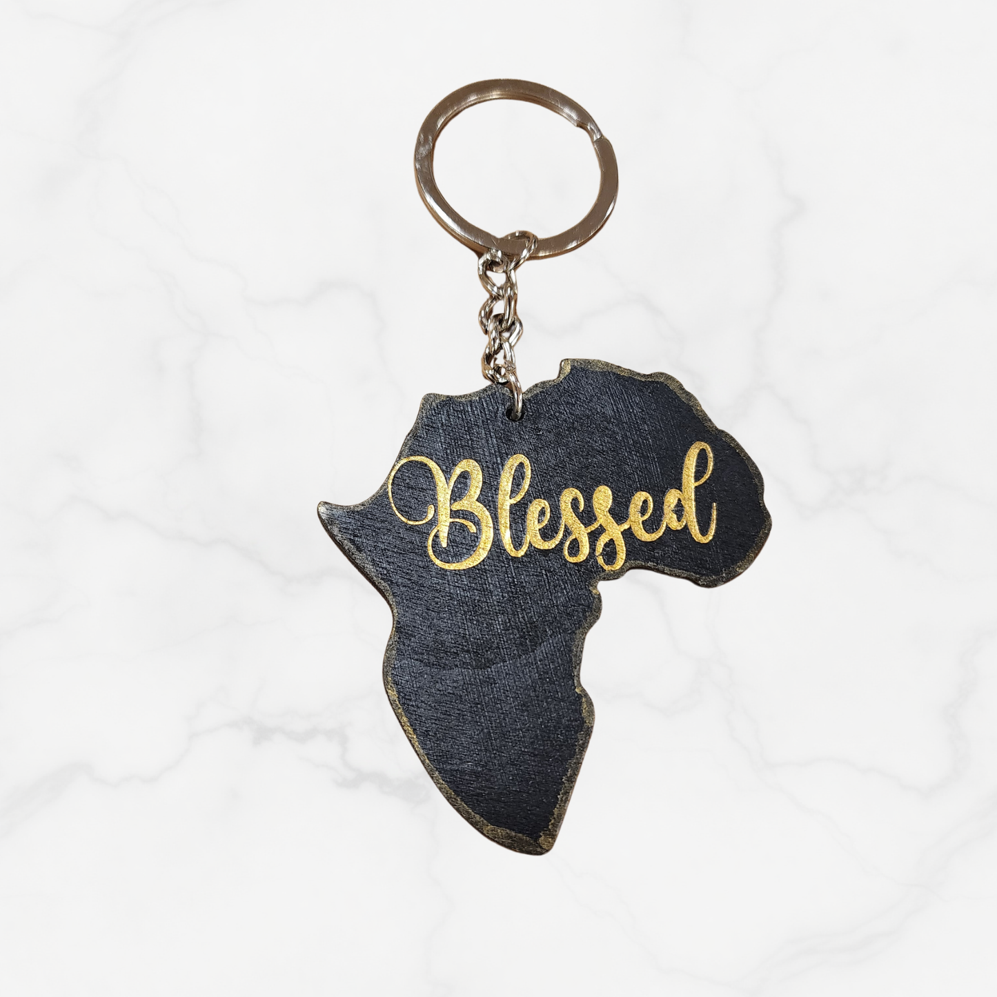 Keychain shaped like Africa with 'Blessed' text on a white background
