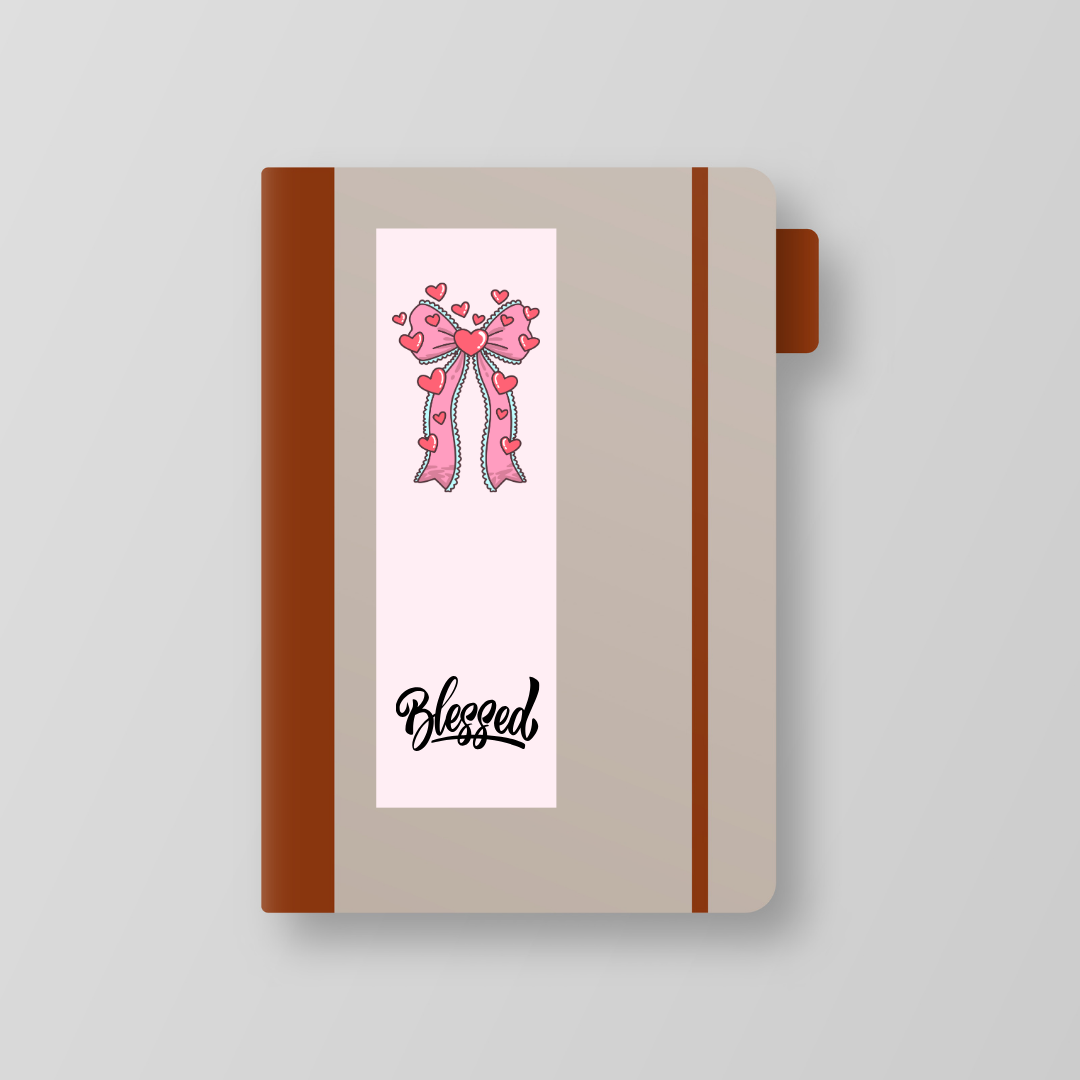 Notebook with a decorative ribbon and 'Blessed' text on a white background