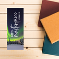 Bookmarks with 'God's masterpiece' design on a wooden surface