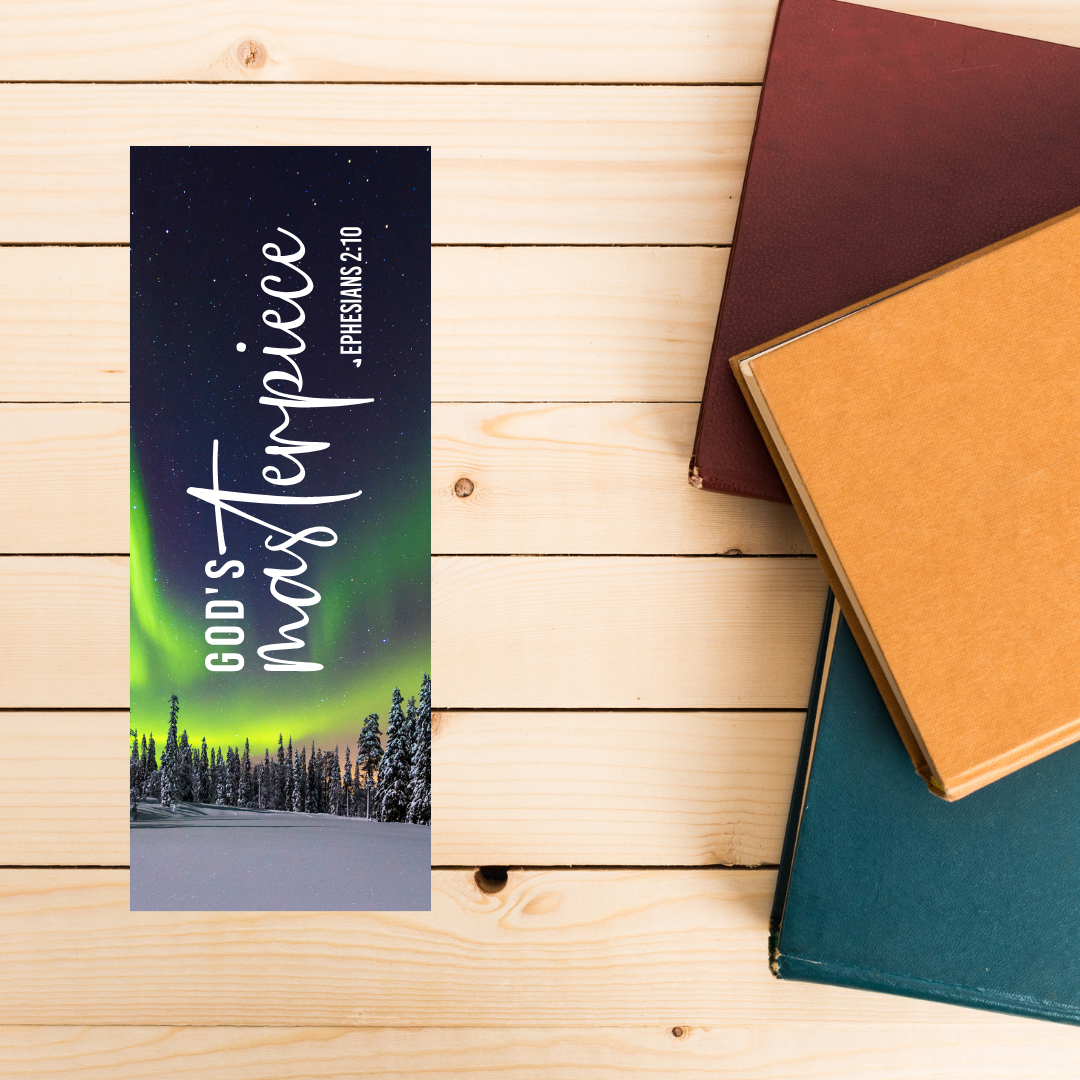 Bookmarks with 'God's masterpiece' design on a wooden surface