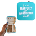 Turquoise jewelry case with 'I am Fearfully and Wonderfully Made' text, held open to show interior.