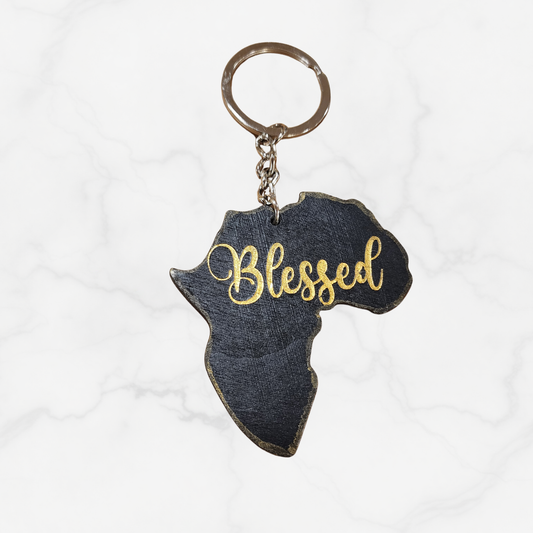 Keychain shaped like Africa with 'Blessed' text on a white background