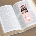 Open book with a pink bookmark featuring text and a duck illustration on a wooden surface.